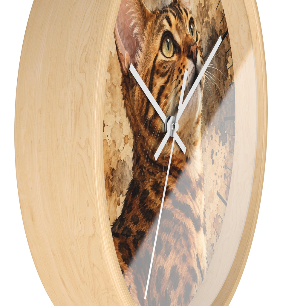 Round wall clock with a light natural wood frame and a printed cat face and fur design on the face, with white hands, shown against a plain white background.