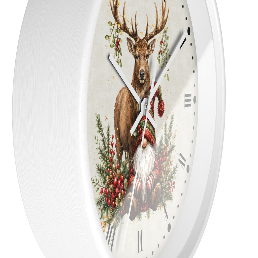 A round white wall clock with a festive illustration featuring a brown deer, green pine branches, red berries, and a gnome in a red hat and white coat on the clock face.