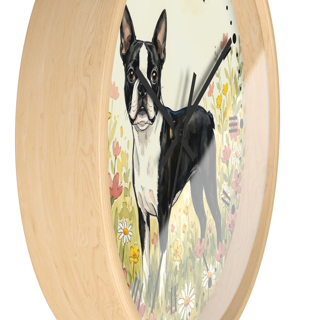 Round wall clock with a light natural wood frame and a printed illustration of a black and white Boston Terrier standing in a flower field, shown against a plain white background.