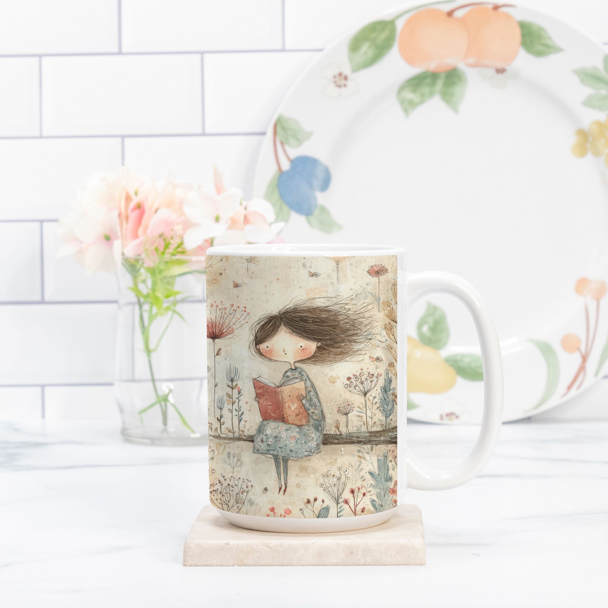 Mug with a design of a girl reading a book, placed on a surface with a decorative plate in the background.