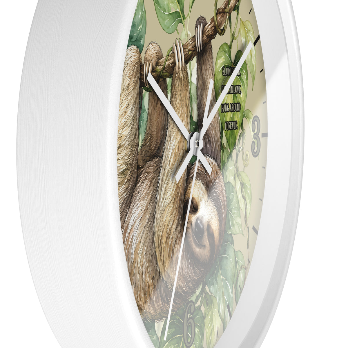 A round white wall clock with a printed illustration of a brown sloth hanging from a tree branch among green leaves on the face, shown against a plain white background.