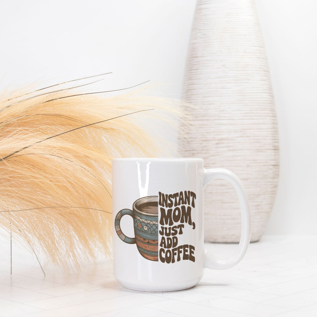White mug with 'Instant Mom, Just Add Coffee' text on a white background