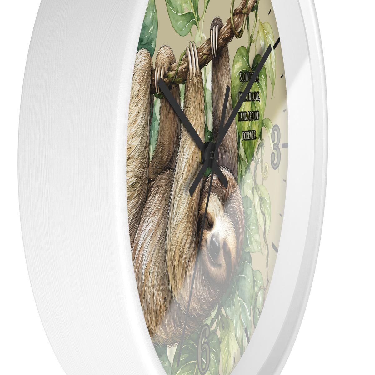 A round wall clock with a white textured frame and a printed face showing a sloth hanging from ropes among green leaves. Black clock hands and small black numerals are visible against a light neutral background.