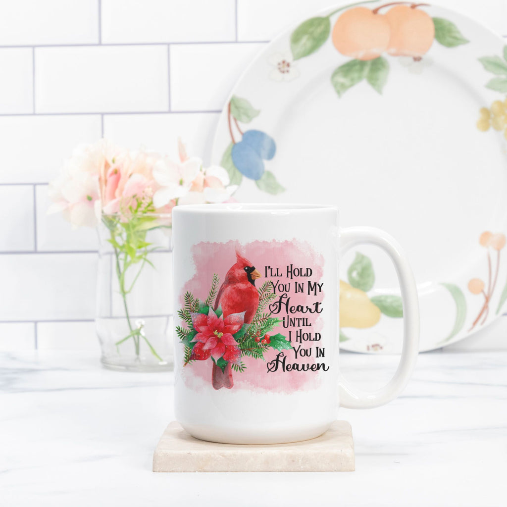 Mug with floral design and text, placed on a white surface with a decorative plate in the background.