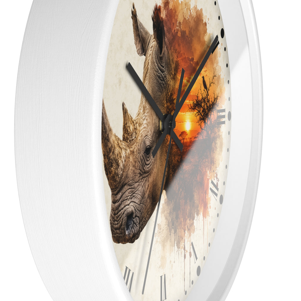 A white round wall clock with a printed design of two rhinoceros heads over an orange sunset and tree silhouette on the face, with black hands and Roman numerals.