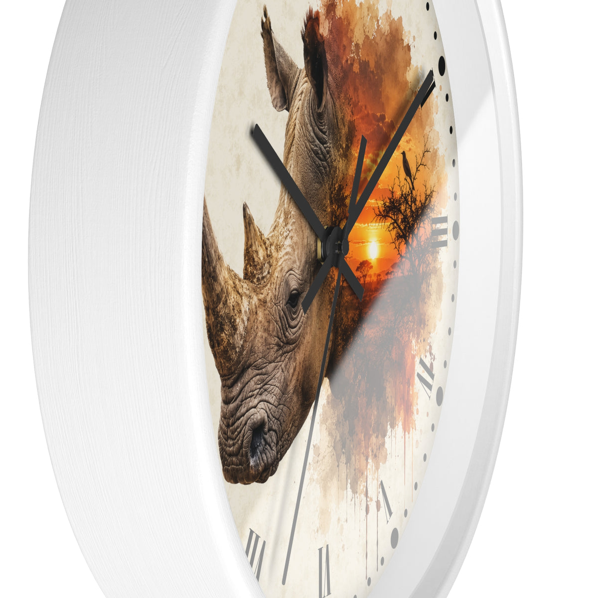 A white round wall clock with a printed design of two rhinoceros heads over an orange sunset and tree silhouette on the face, with black hands and Roman numerals.