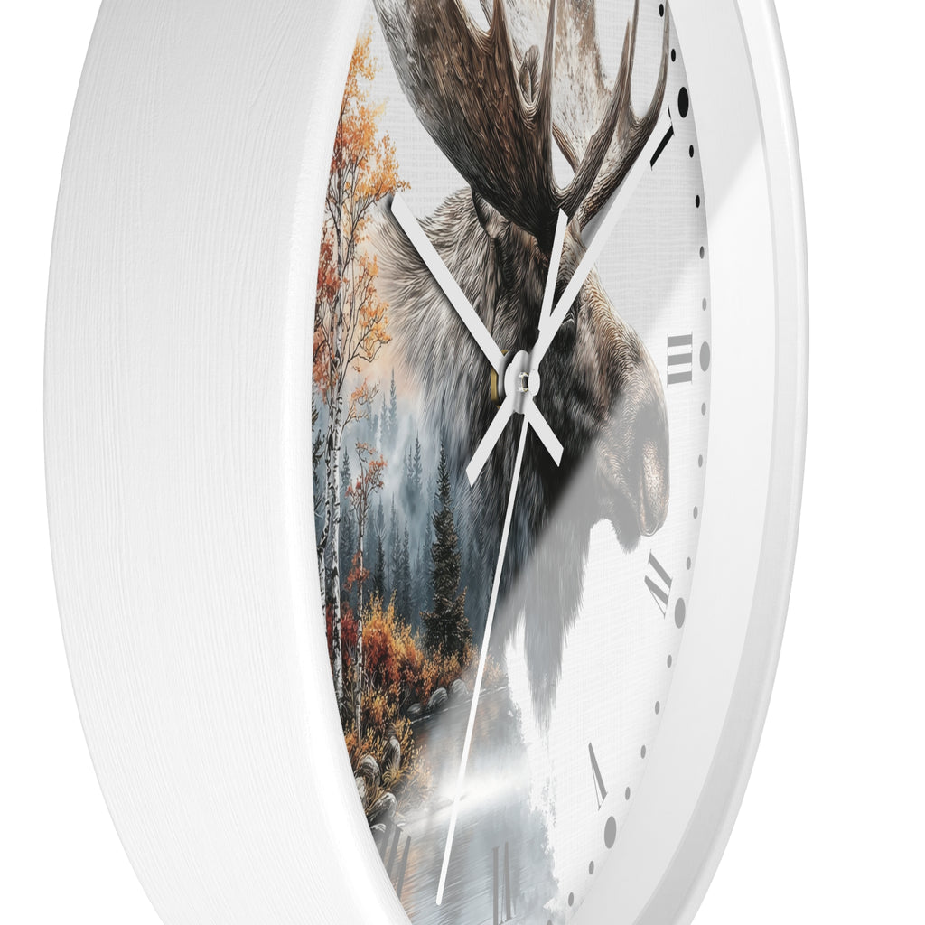 A white round wall clock with a printed design on the face showing a moose head over an autumn forest scene, photographed against a plain white background.