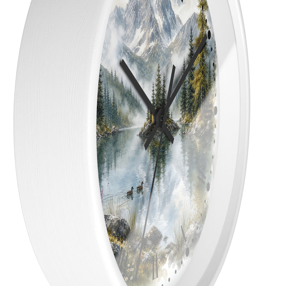A white oval wall clock featuring a scenic print of a misty mountain lake with pine trees, ducks, and snow-capped peaks, with black hands and small black dot hour markers.