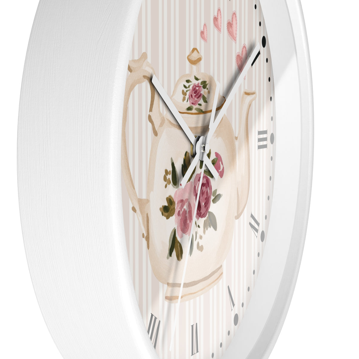 Round wall clock with a white frame and a decorative dial featuring a cream teapot with pink roses, green leaves, and a striped background with small pink hearts.