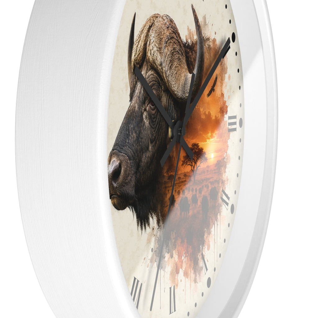A round wall clock with a white frame and a printed face featuring a close-up bison head over an orange sunset landscape, shown against a plain white background.