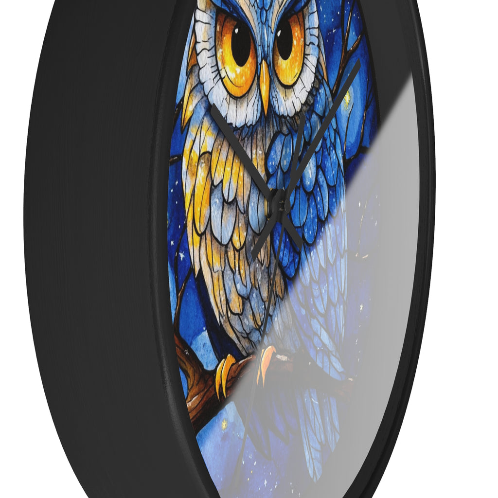 Round wall clock with a black frame and a stained-glass style illustration of an owl with blue, yellow, and white feathers on a white background.