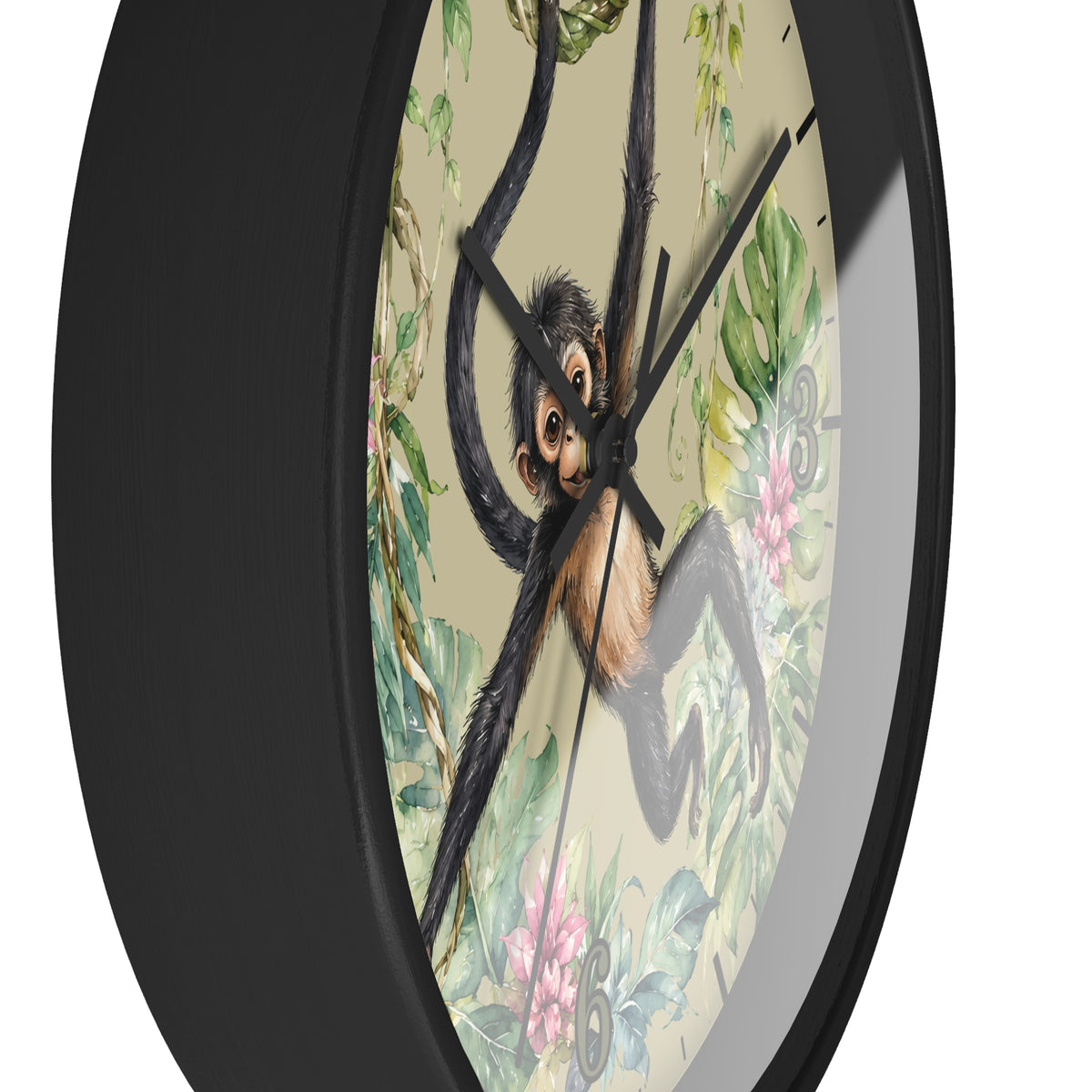 A close-up of a round wall clock with a black frame and a tropical jungle design featuring a hanging spider monkey, green leaves, and pink flowers on a light beige background.
