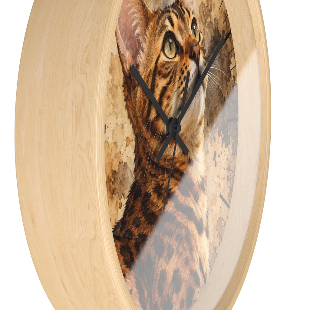 Round wall clock with a light natural wood frame and a printed cat face and fur design on the face, with black hands, shown against a white background.