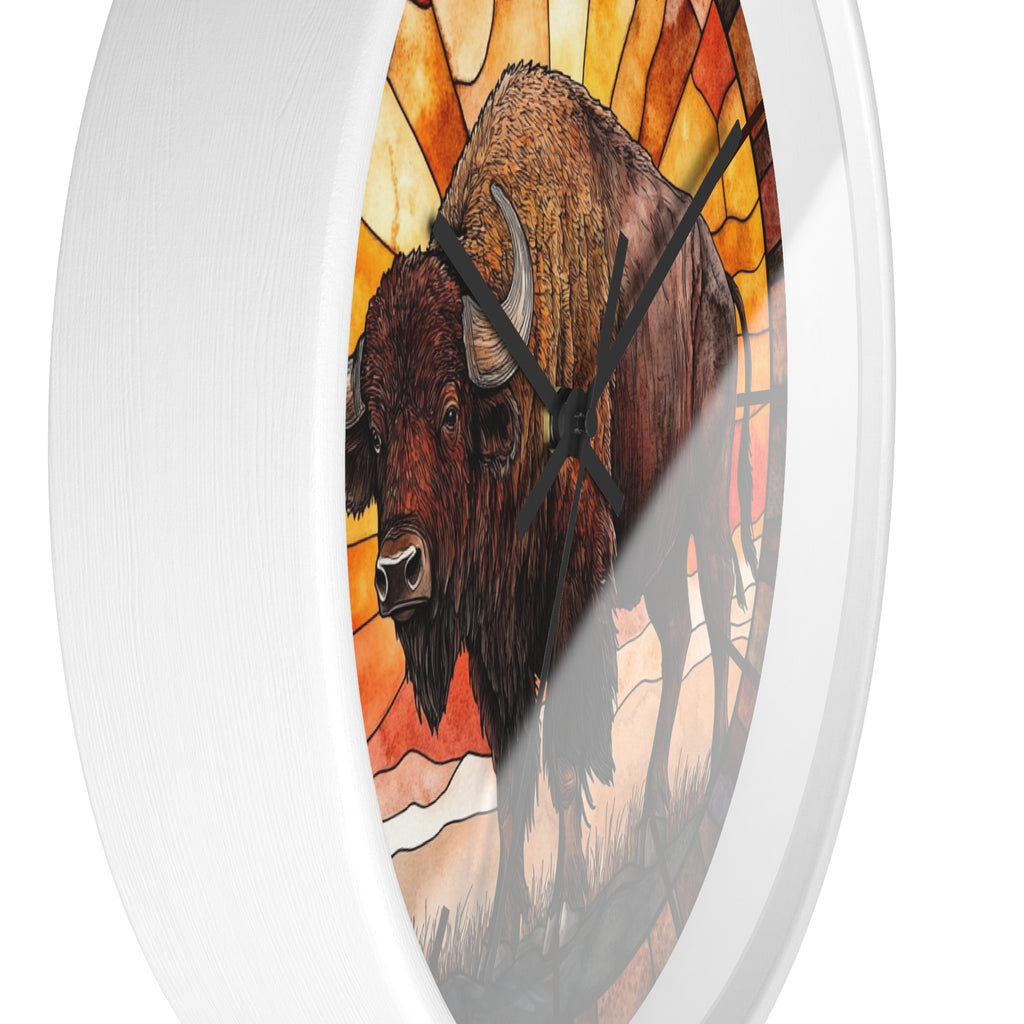 Round wall clock with a white frame and a stained-glass-style illustration of two bison in front of warm orange and yellow panels, shown on a white background.