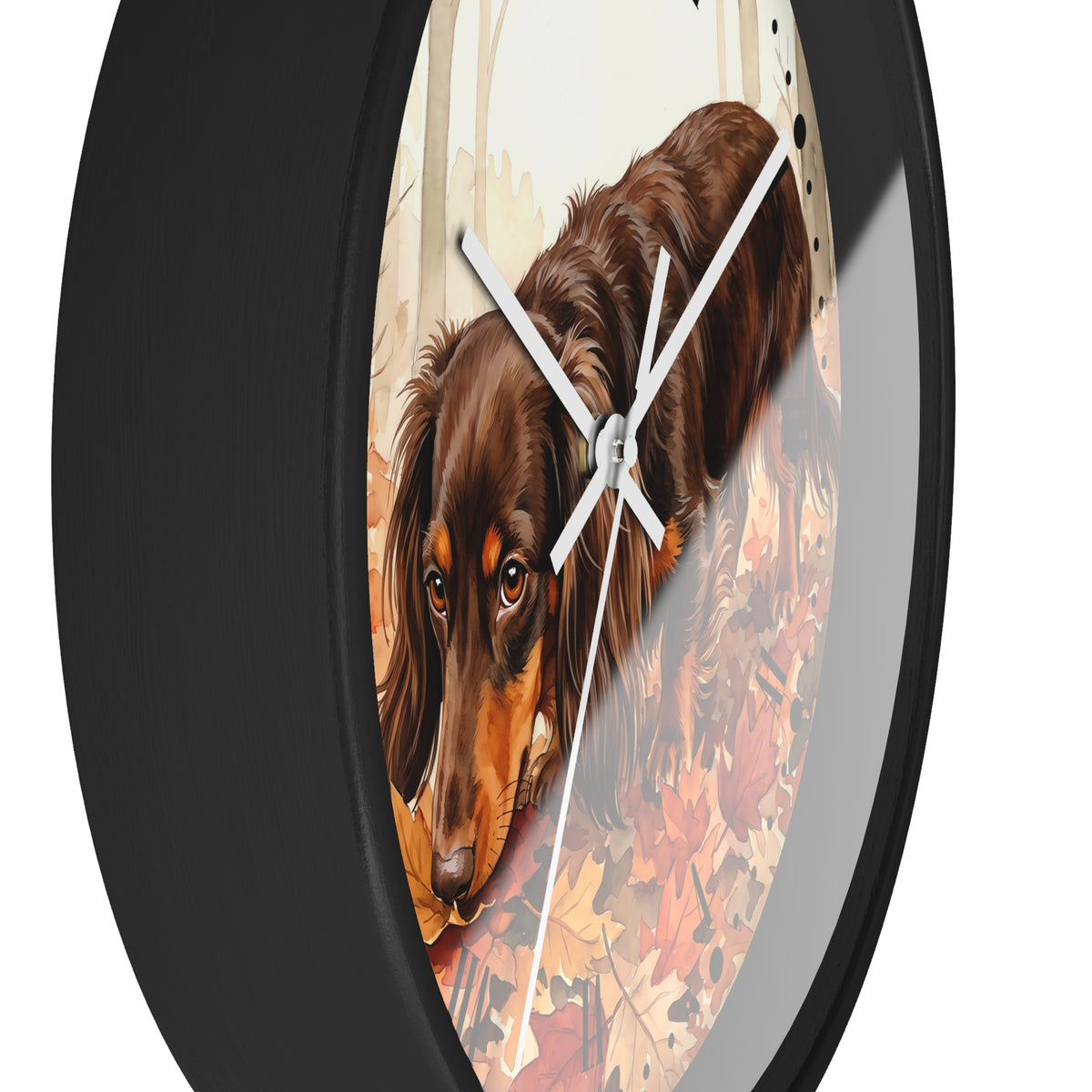 Round wall clock with a black frame and white hands, featuring a printed illustration of a brown dachshund dog walking through autumn leaves.