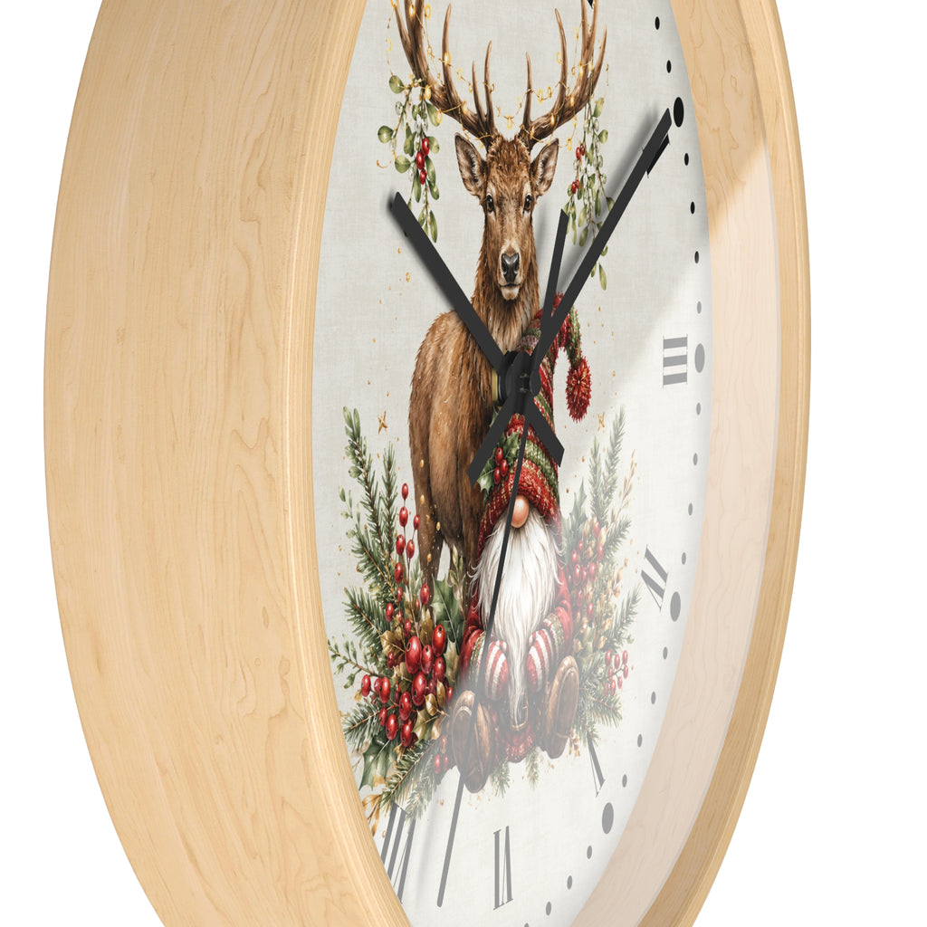 A round wall clock with a light natural wood frame and a white clock face featuring an illustration of a deer, pine branches, red berries, and a gnome.