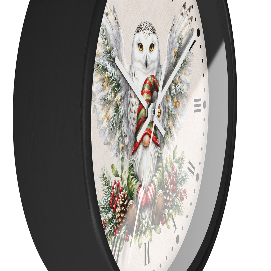 A round wall clock with a black frame and a festive printed face featuring a snowy owl with wings, a red striped scarf, holiday greenery, and candy canes on a light background.
