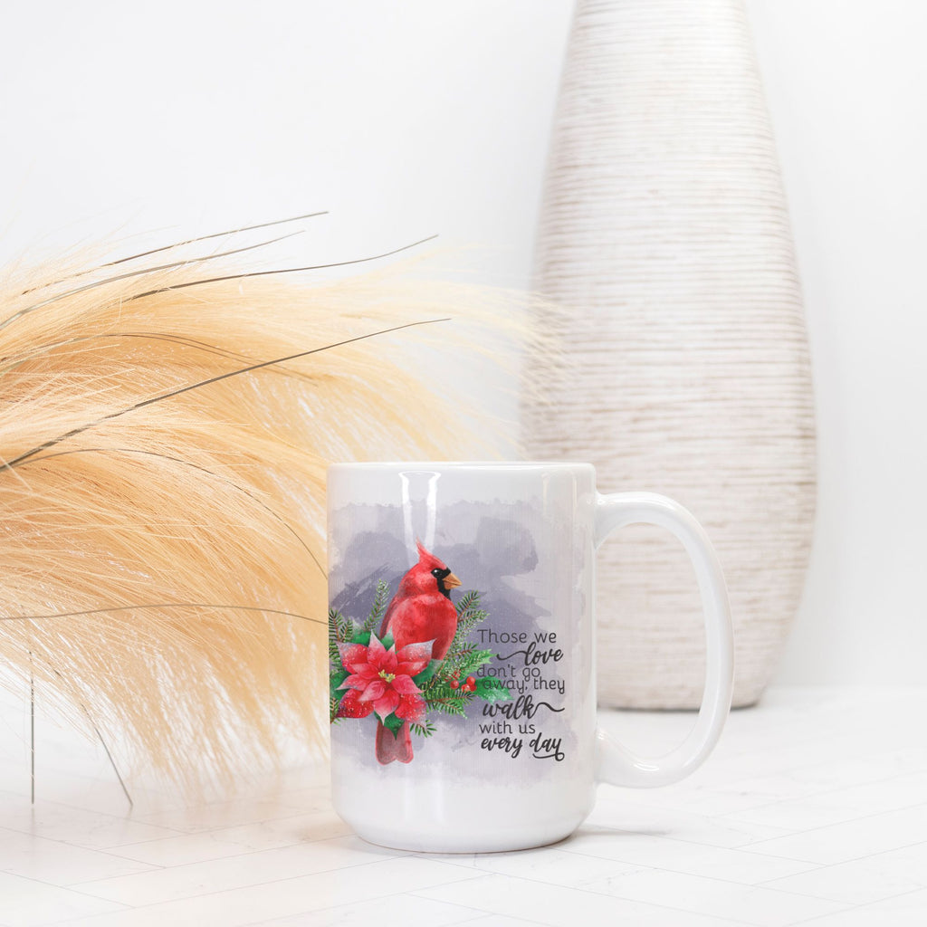 White mug with a cardinal and poinsettia design on a white background