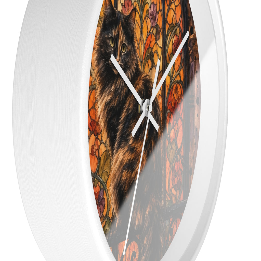 Round white wall clock with a printed artwork insert showing a black and brown cat in front of an orange floral stained-glass style background, photographed against a white studio background.