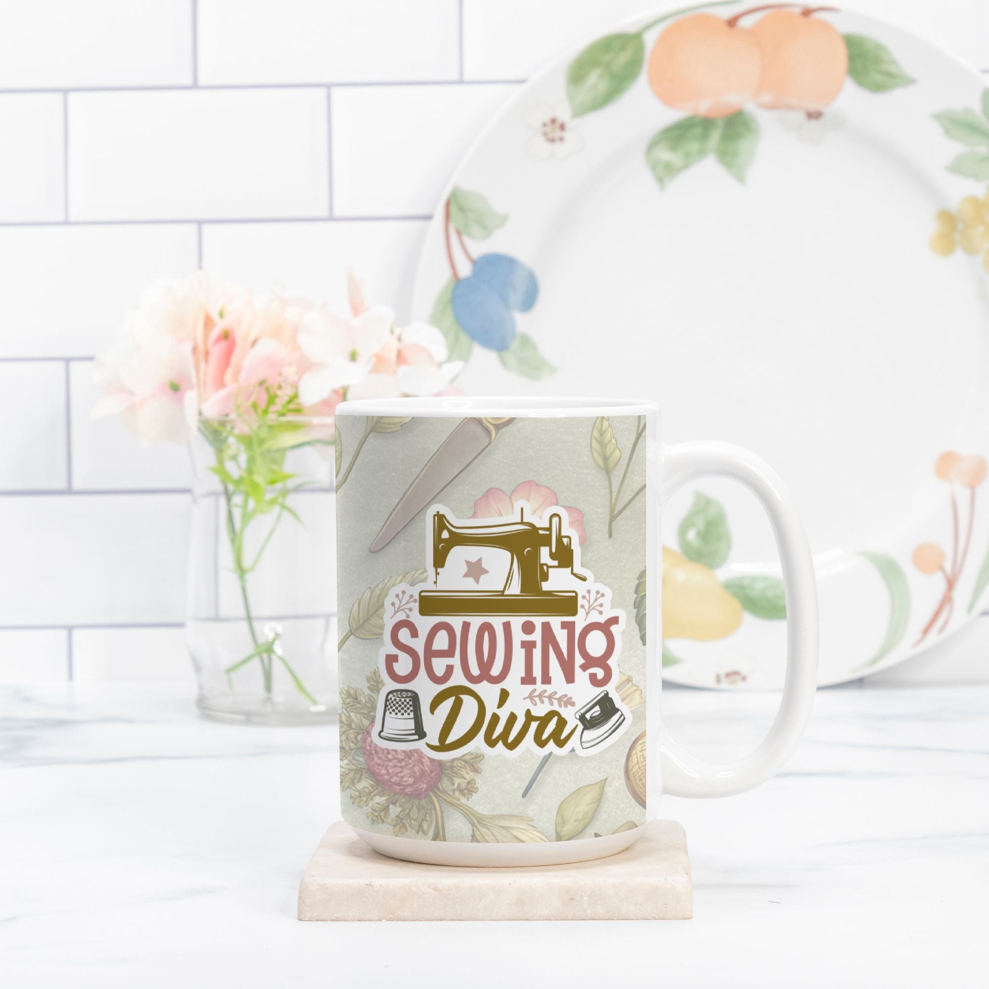 Mug with 'Sewing Diva' design on a white surface with a floral plate in the background.