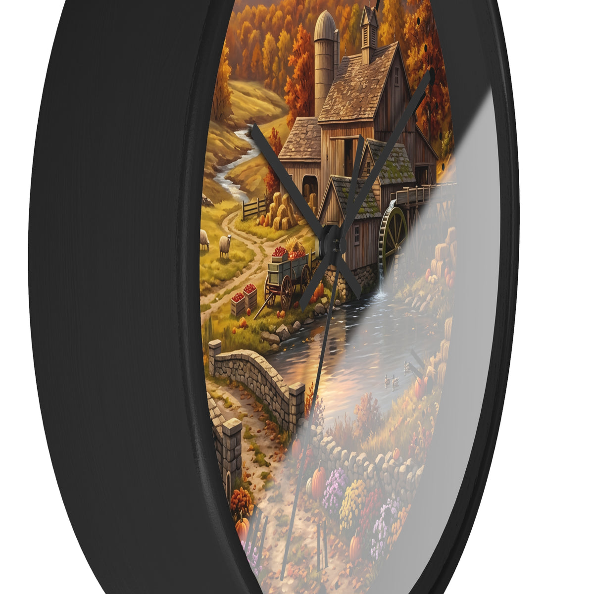 Round wall clock with a black frame and a scenic autumn landscape illustration featuring a mill, water, stone walls, and orange trees, shown against a white background.