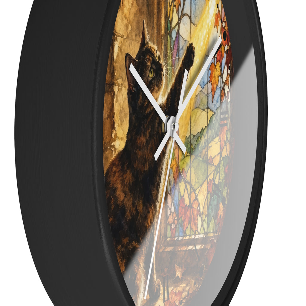 Round wall clock with a black frame and a printed design featuring a dark cat reaching toward colorful stained-glass-style light on a white background.