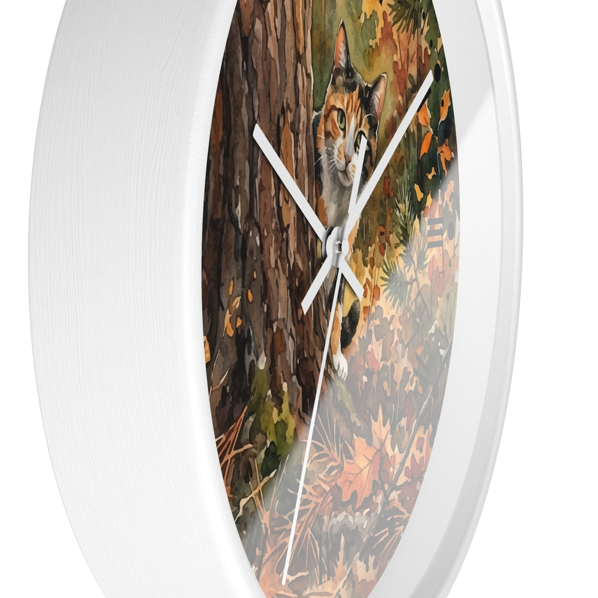 Round wall clock with a white frame and a printed autumn forest scene featuring a calico cat among tree bark and fallen leaves, shown against a white background.