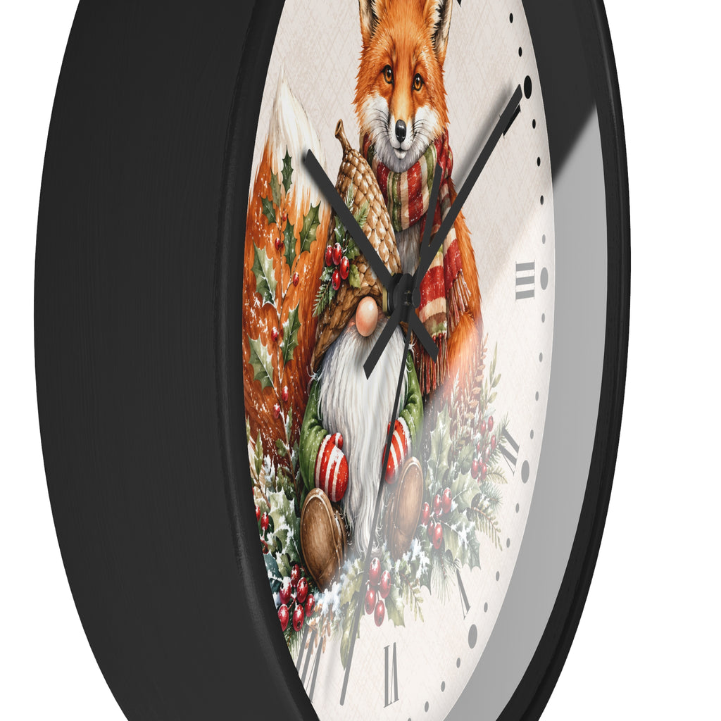 A close-up of a round wall clock with a black frame and a white dial featuring a detailed illustration of a red fox wearing a plaid scarf and holding a basket, surrounded by winter greenery and candy canes.