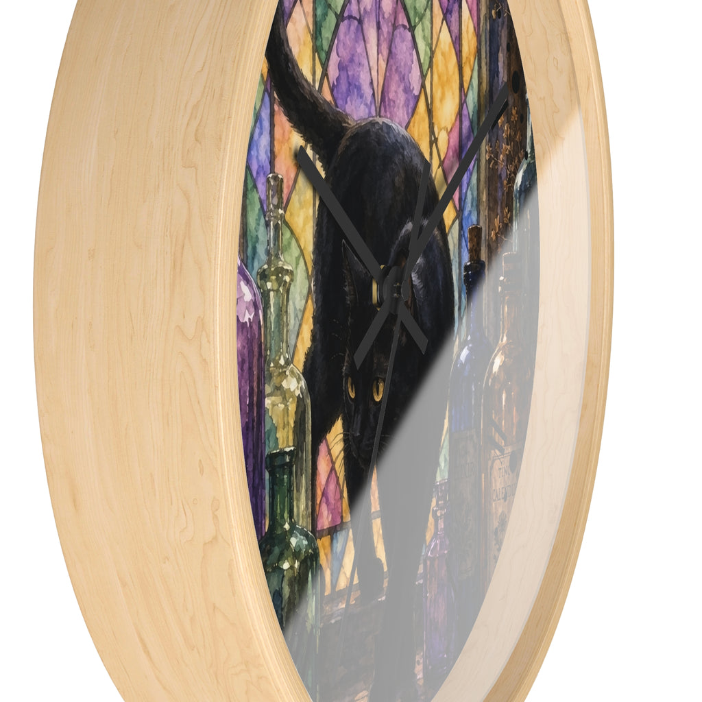 Round wall clock with a light natural wood frame and a printed artwork of a black cat in front of a colorful stained-glass-style background, shown on a white background.