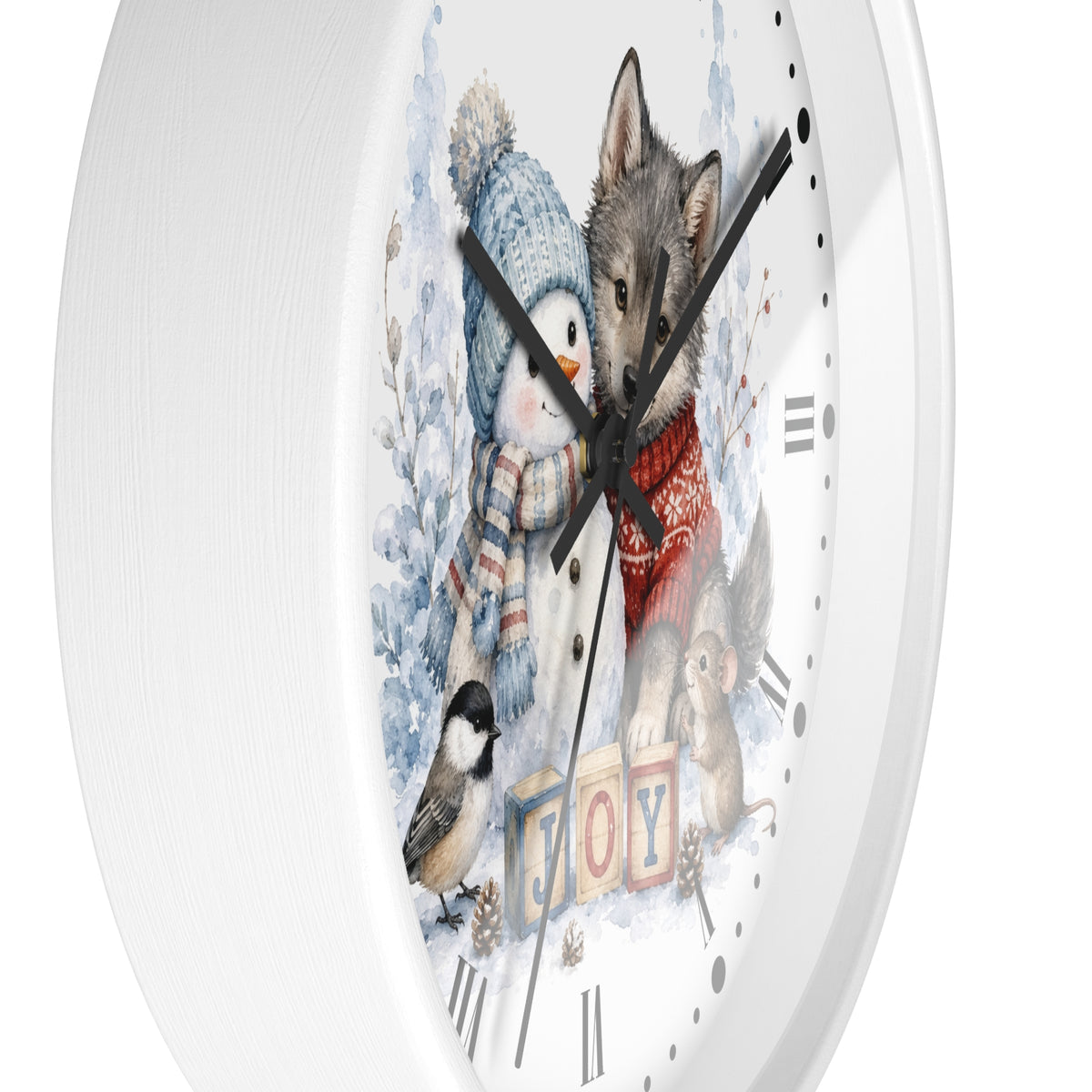 A round white wall clock with a winter-themed illustration on the face, featuring a penguin, wolf, squirrel, bird, and the word "JOY" in colorful blocks. The clock is shown against a clean white background.