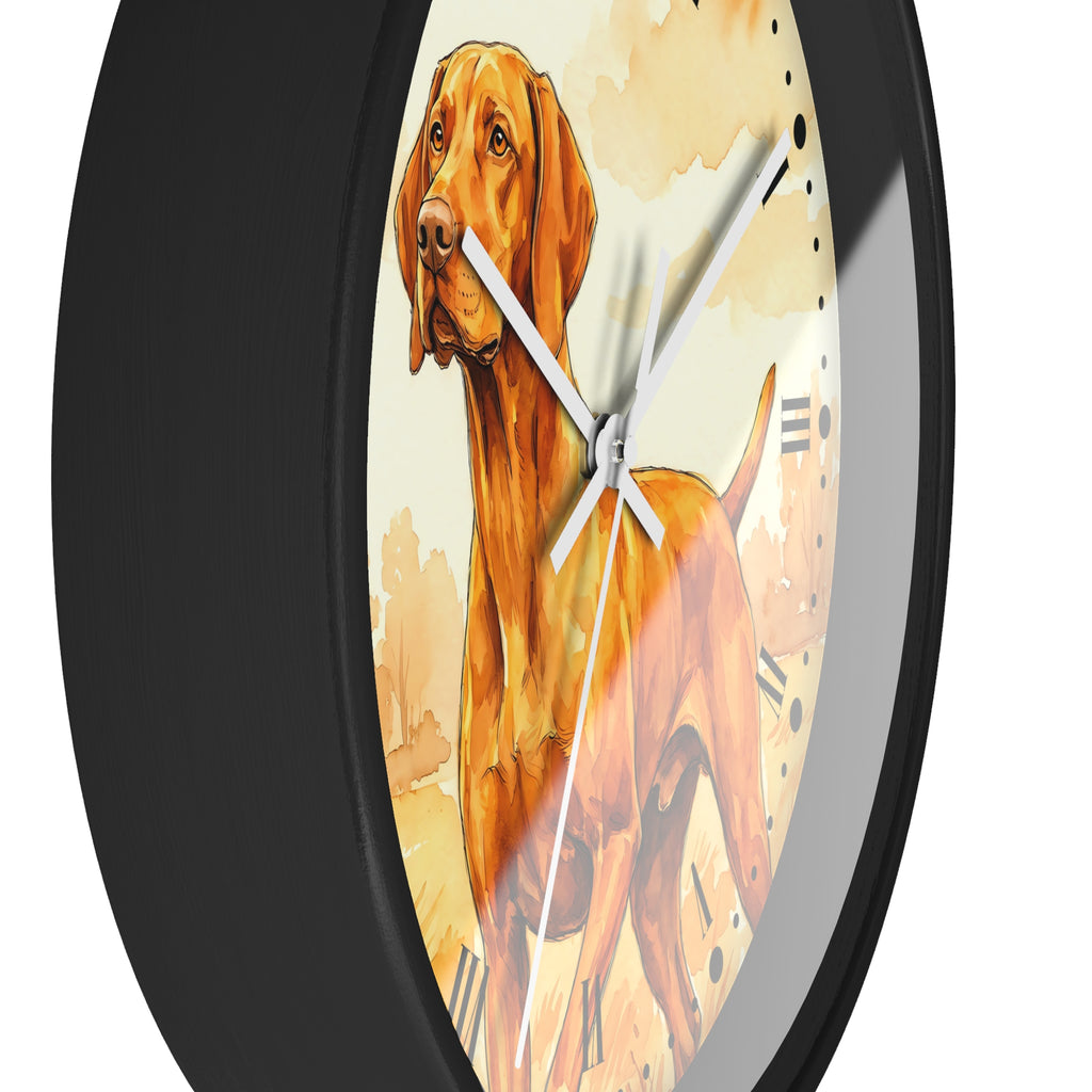 A close-up of a round wall clock with a black frame and a printed dog illustration on the face. The dog artwork is warm brown and orange with cream background tones, and the clock hands are white.