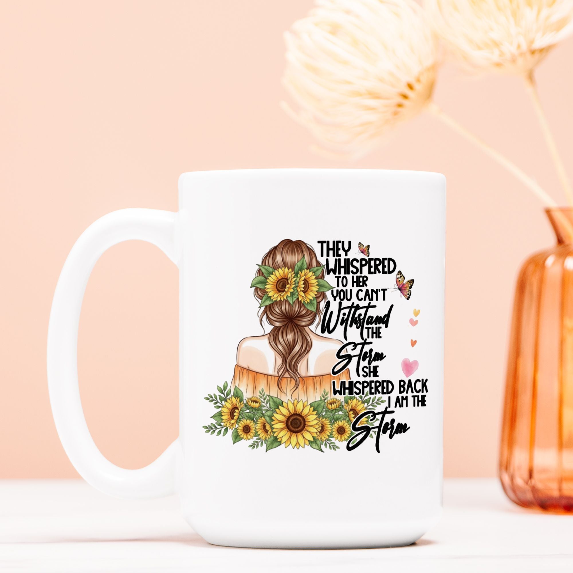 White mug with a design of a woman with sunflowers and text on a peach background
