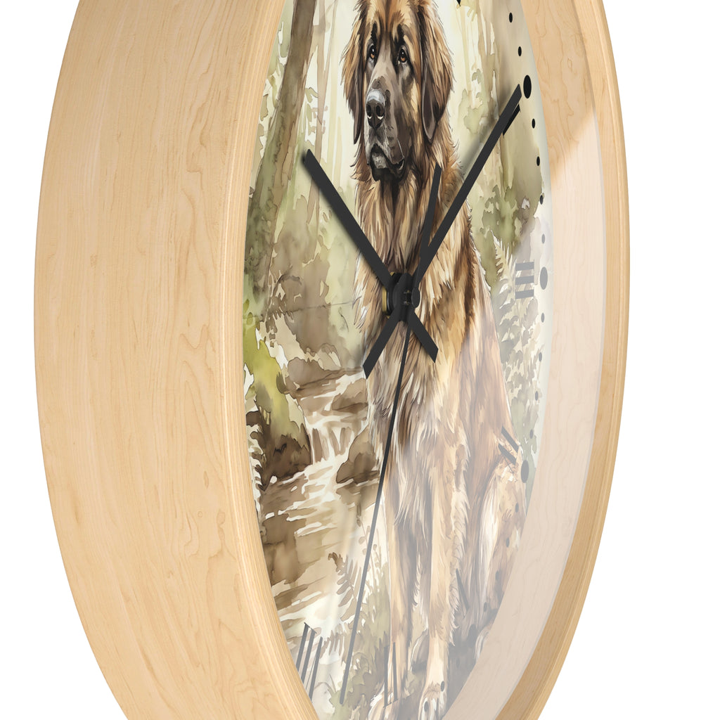 Round wall clock with a light natural wood frame and a printed illustration of a Leonberger dog sitting by a stream, with black clock hands on a white background.