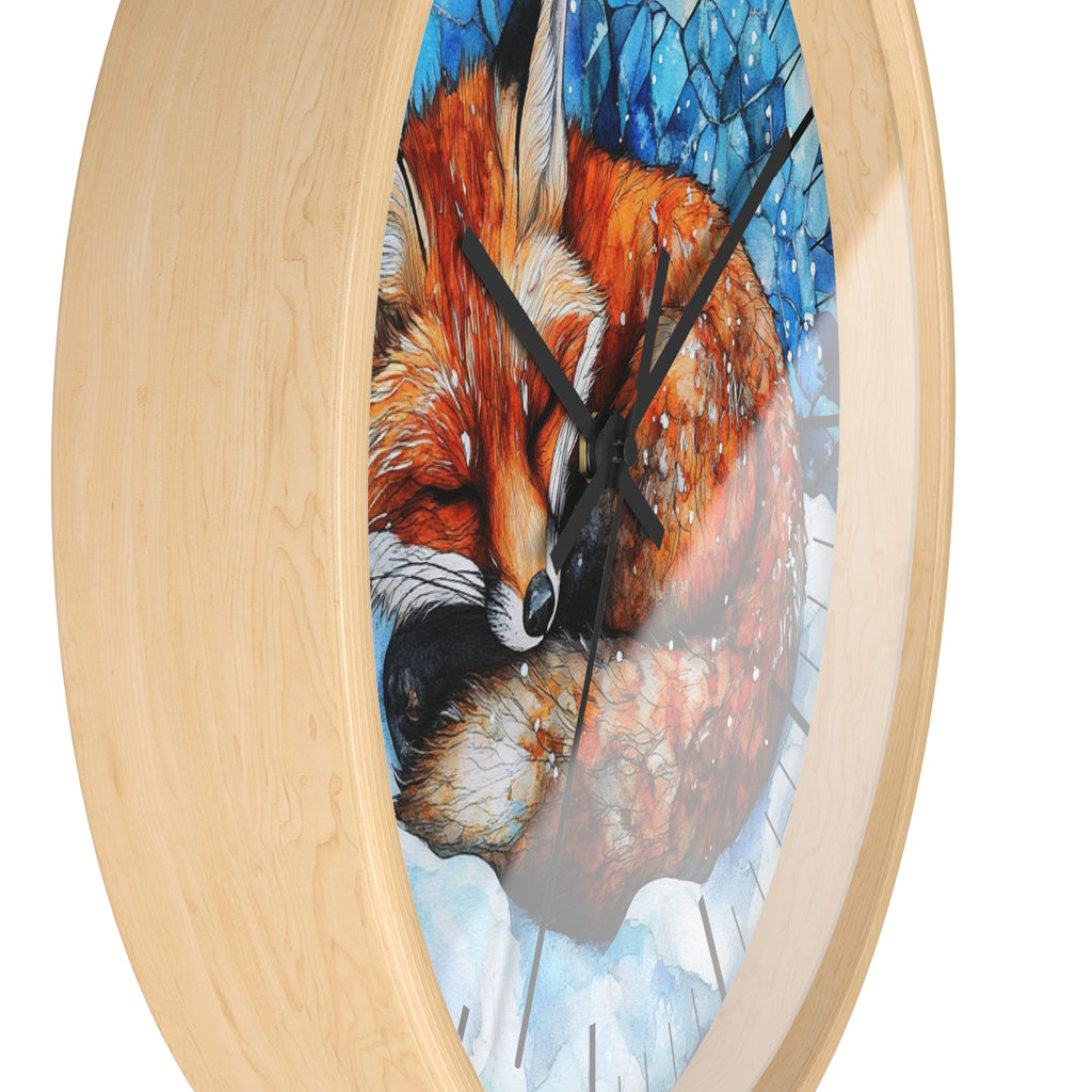 Oval wall clock with a light natural wood frame and a printed illustration of a sleeping fox in warm orange, brown, cream, and blue tones on the face.