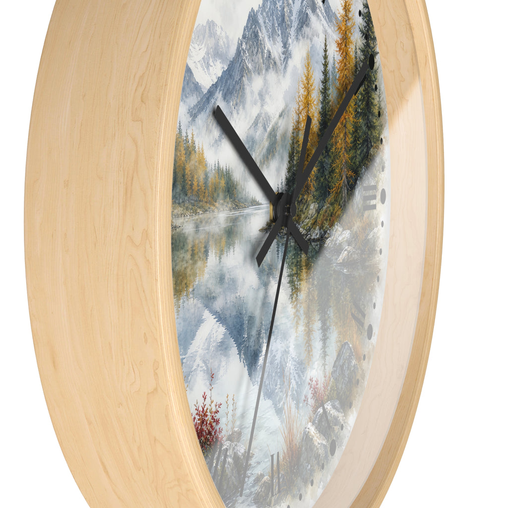 Round wall clock with a light natural wood frame and a scenic landscape print featuring mountains, a reflective lake, evergreen trees, and black clock hands.