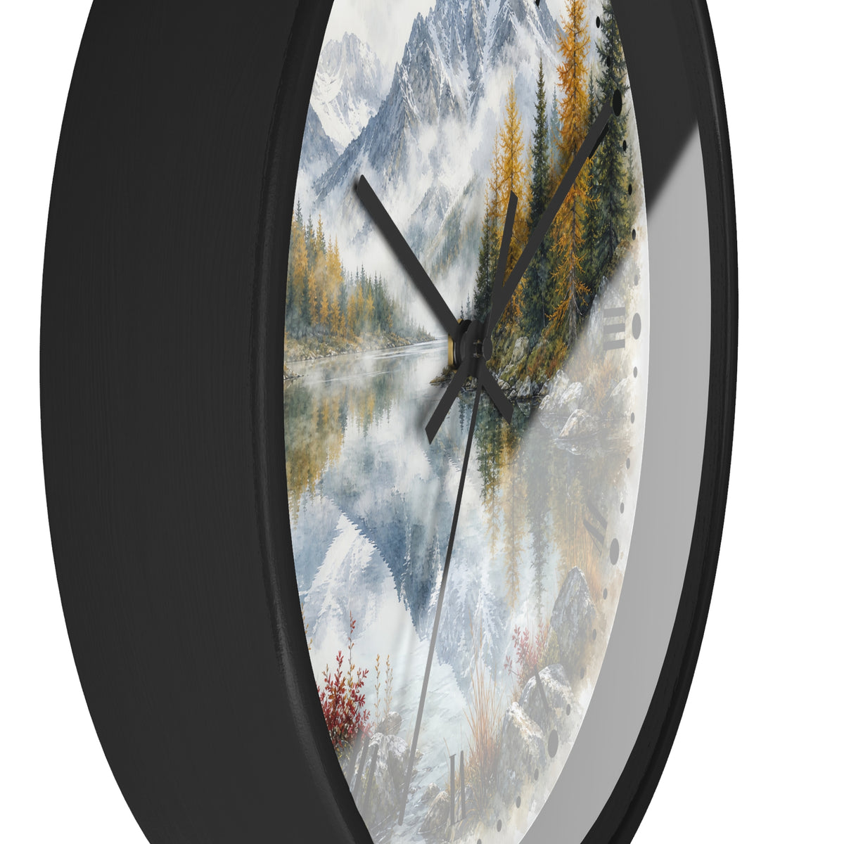 Round wall clock with a black frame and a scenic landscape print featuring snowy mountains, a reflective lake, evergreen trees, and autumn foliage.