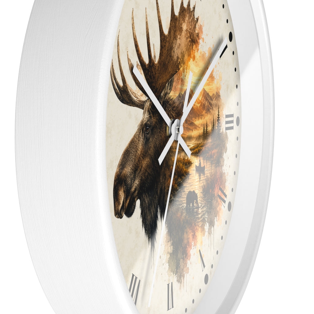 Round wall clock with a white frame and a printed moose head artwork over a warm-toned landscape background, with white hands and black Roman numerals.