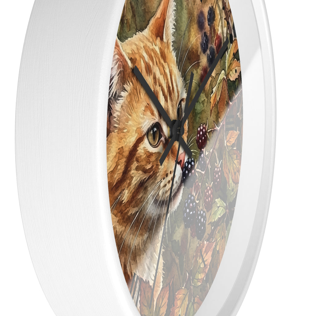 Round wall clock with a white frame and a printed illustration of an orange tabby cat surrounded by autumn leaves and blackberries on the face.