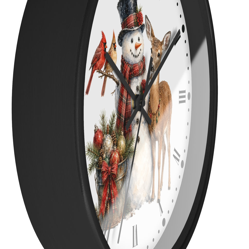 A round wall clock with a black frame and a white face featuring a festive winter illustration of a snowman, a deer, two red cardinals, and holiday ornaments.
