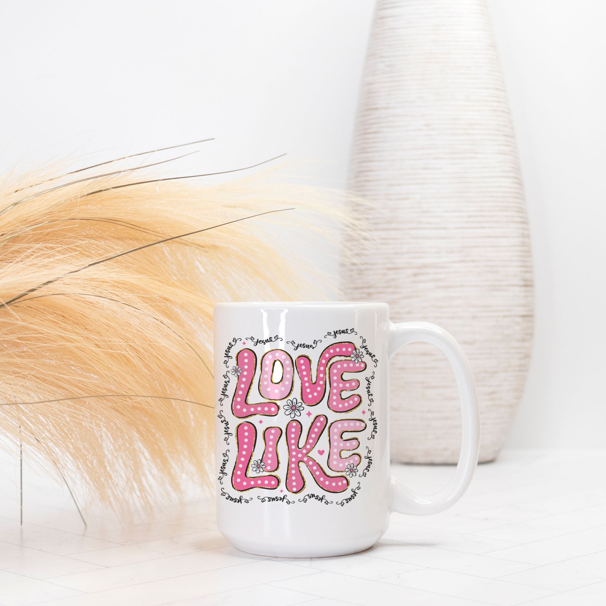 White mug with pink and black text on a white background