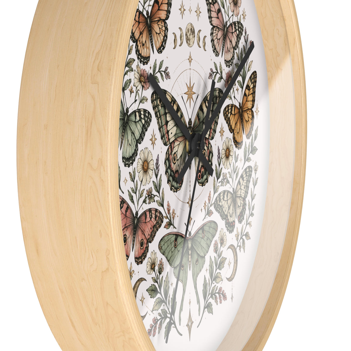 A close-up of a wall clock with a light natural wood frame and a white dial decorated with vintage-style butterflies and botanical illustrations.