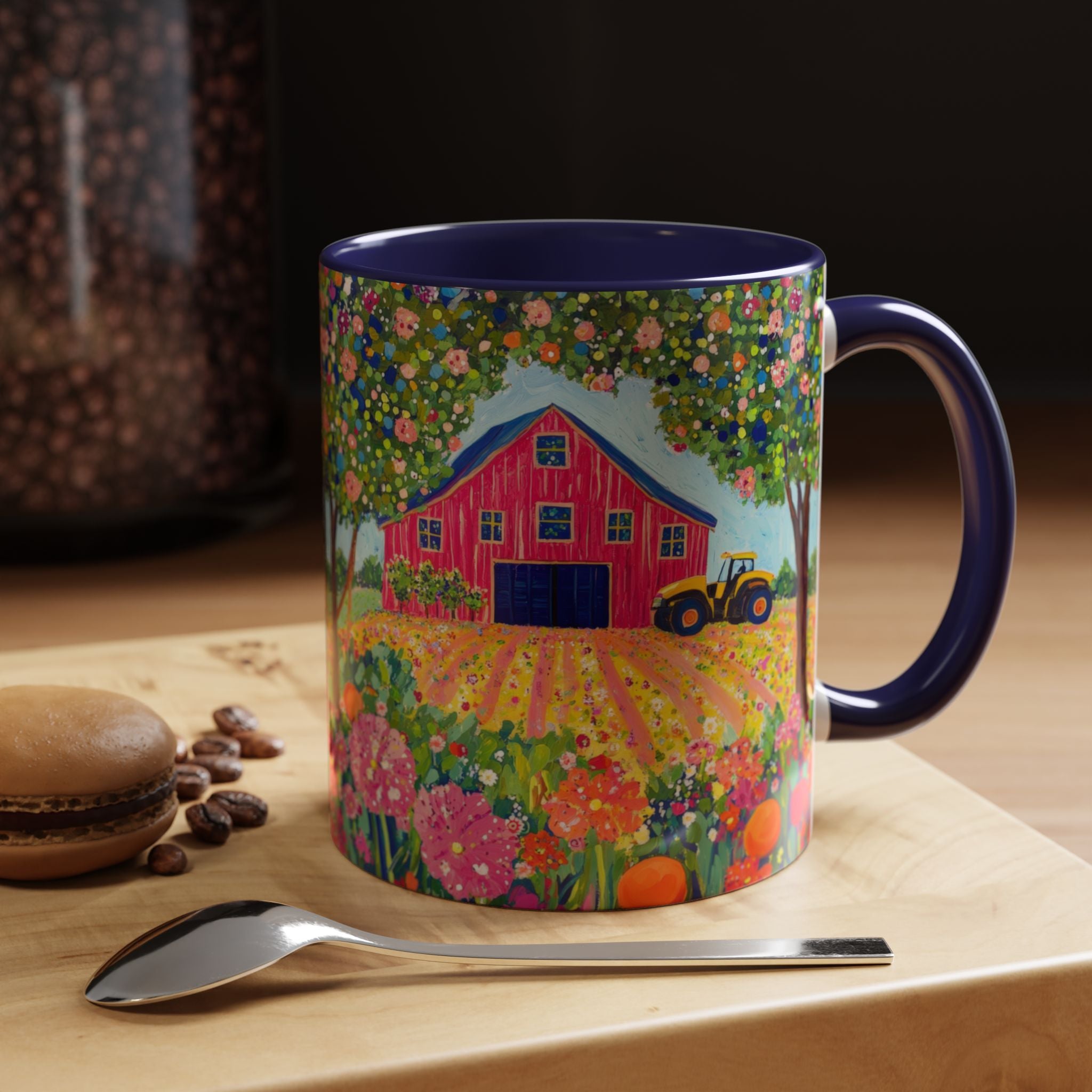 Mug with farm design on a wooden surface with coffee beans and a spoon.