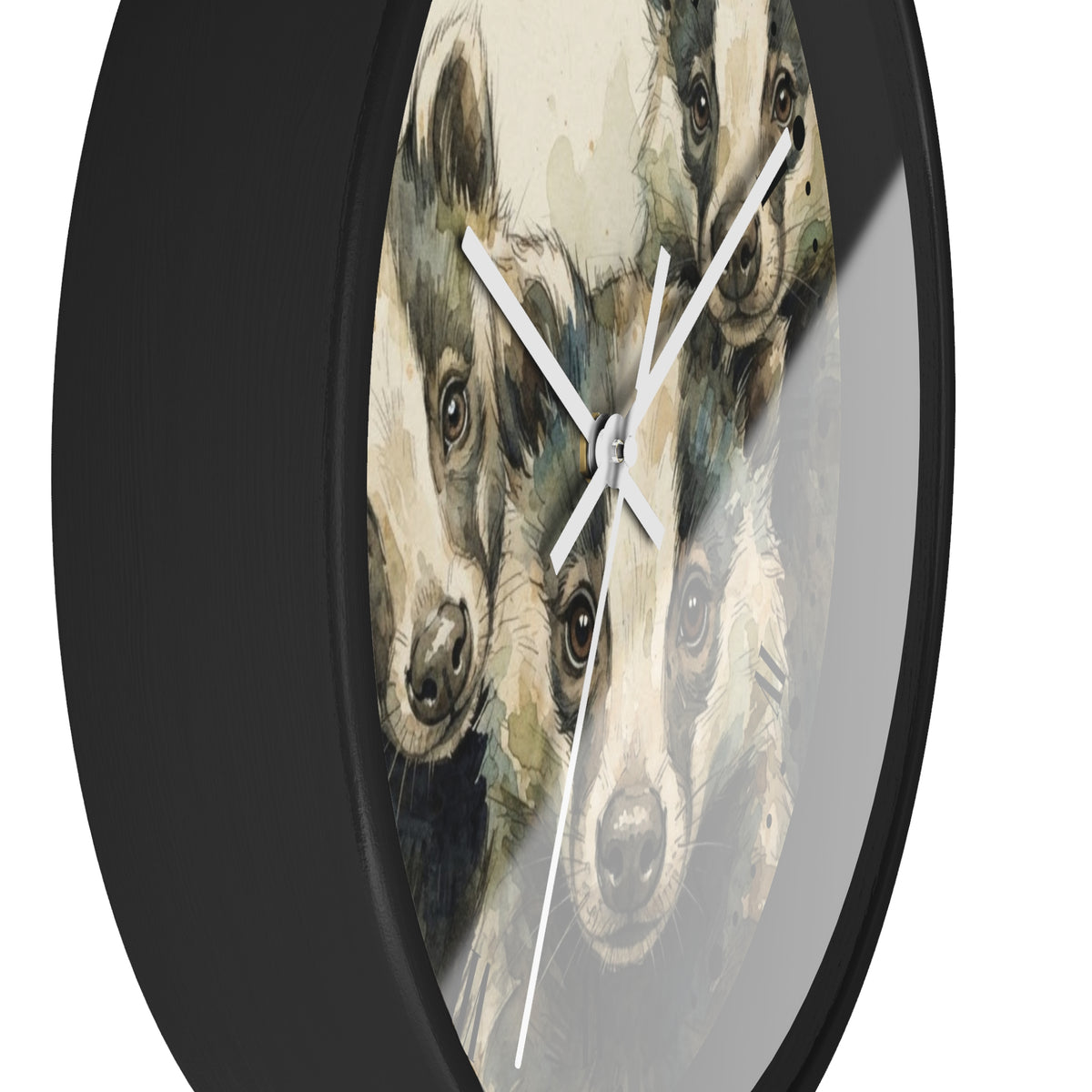 A round wall clock with a black frame and white hands, featuring a printed design of three badger pups on the face. The clock is shown against a plain white background.