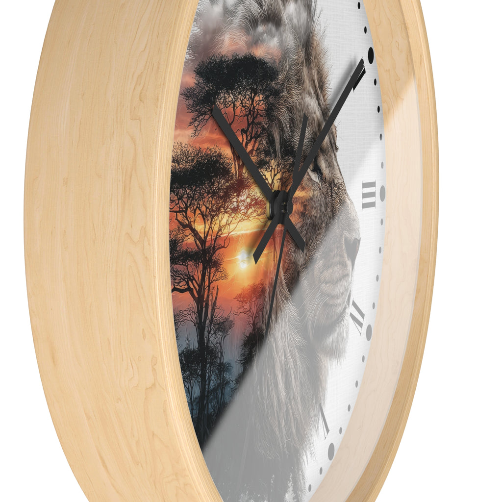 Round wall clock with a light natural wood frame and a printed face featuring a lion face over an orange sunset and tree silhouette scene.