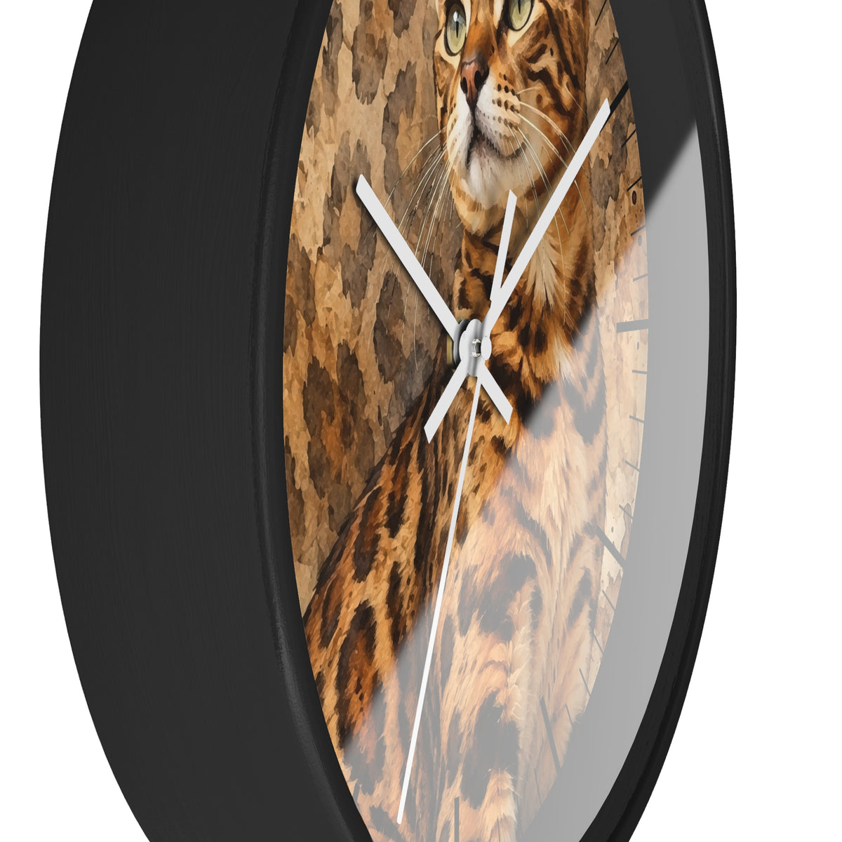A close-up of a round wall clock with a black frame and a printed cat face and fur design on the face, with white clock hands against a white background.