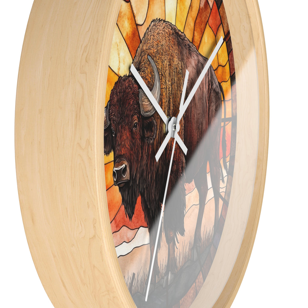 Round wall clock with a light natural wood frame and a stained-glass-style illustration of a bison in warm orange, yellow, and brown tones, shown on a white background.