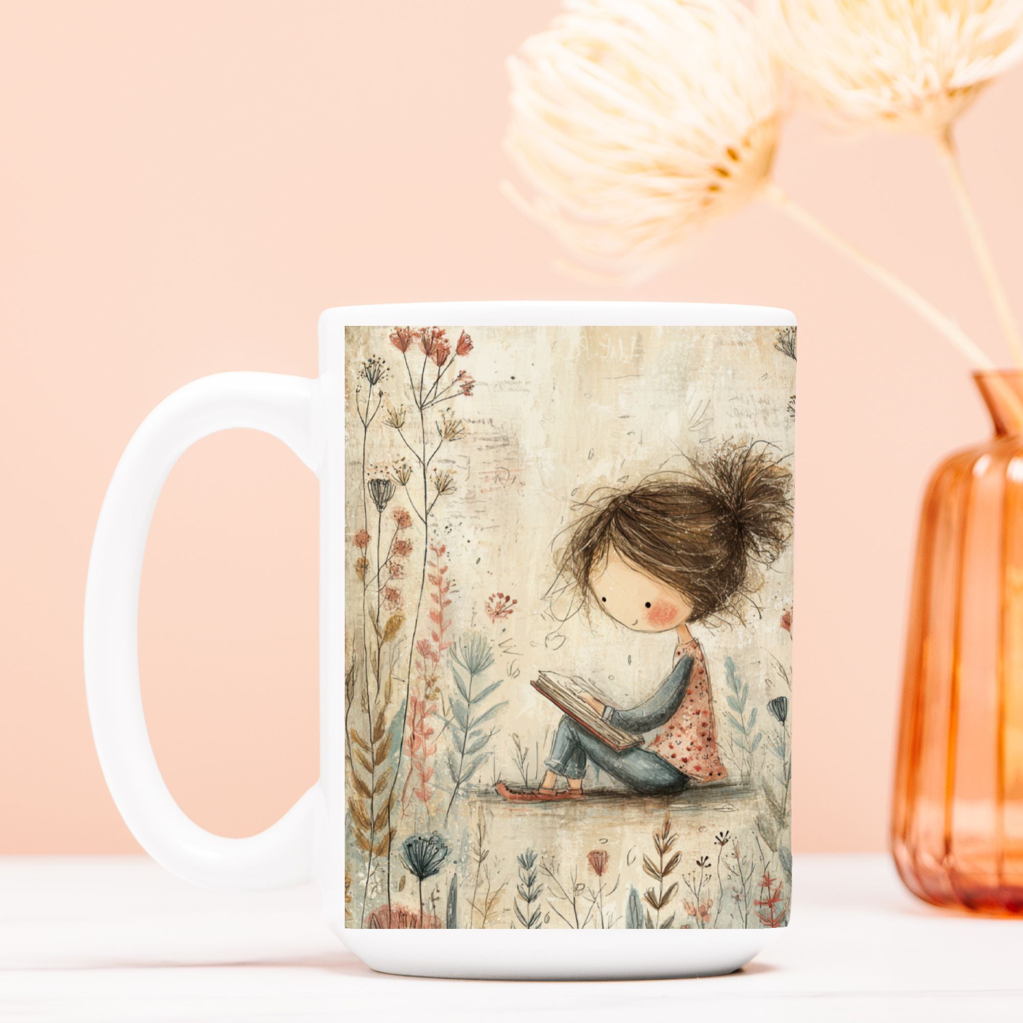 White mug with a decorative design of a girl reading a book surrounded by flowers on a peach background.