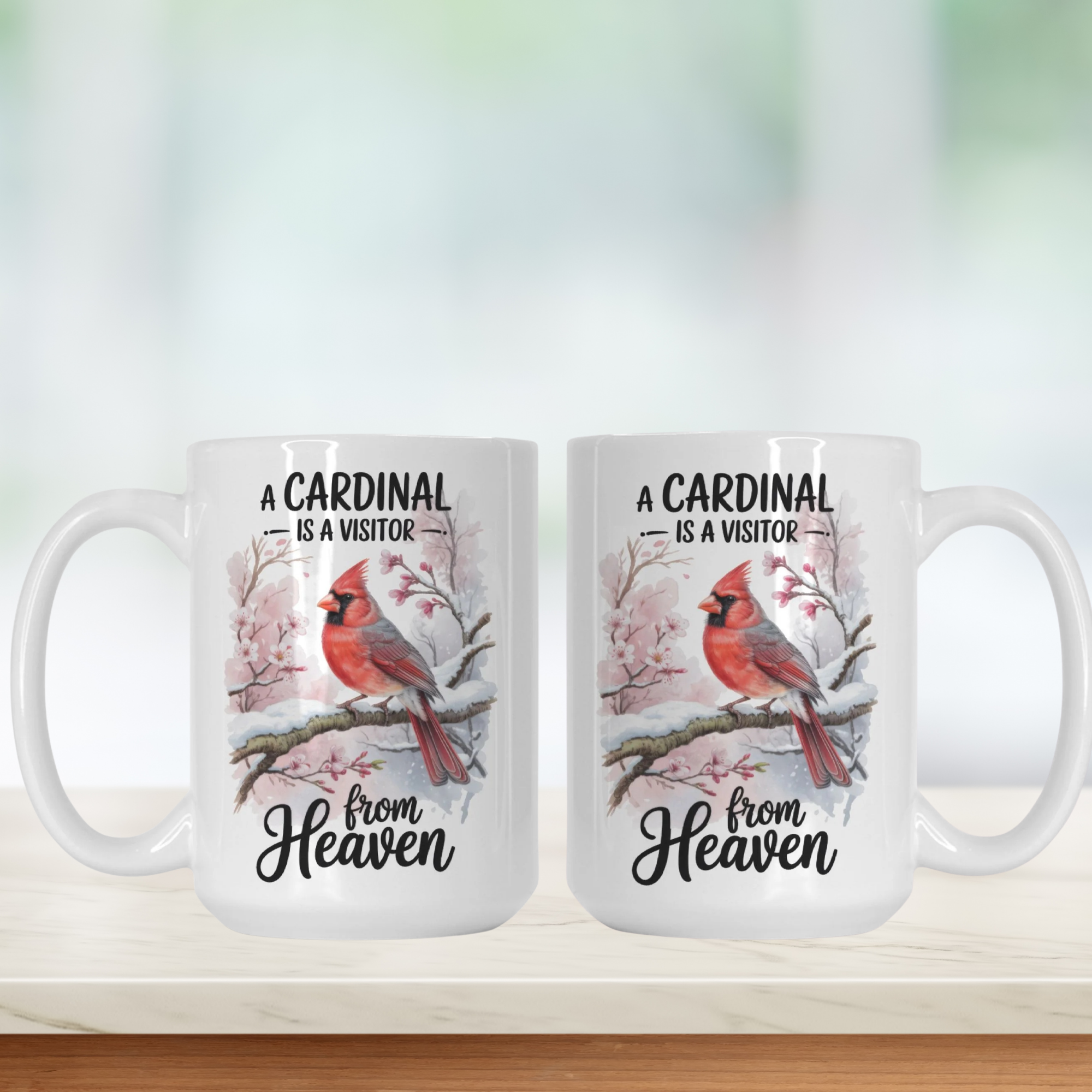 Two white mugs with cardinal illustrations and text on a blurred background