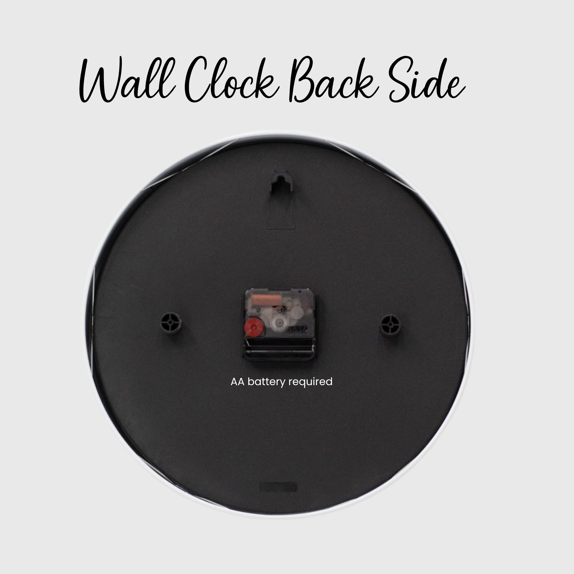 Back side of a wall clock with battery compartment on a light gray background