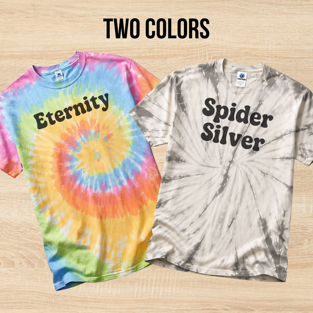 Two tie-dye t-shirts with 'Eternity' and 'Spider Silver' text on a wooden surface.